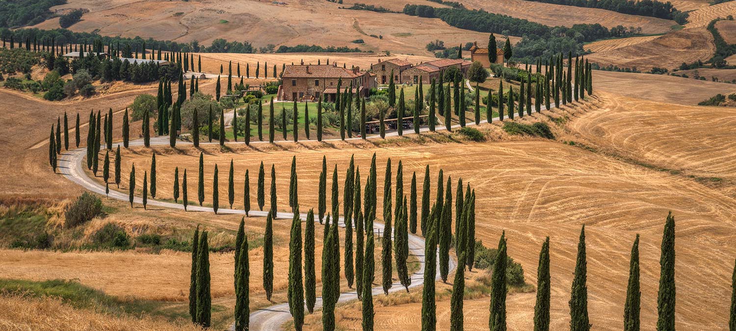 Cinematic landscape of Val d'Orcia rolling hills with cypress trees, typical location for car commercials and campaigns in Tuscany