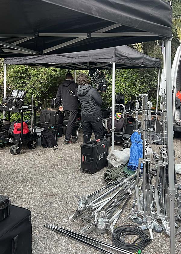 Production basecamp setup with tents and video equipment outside a private villa location in Liguria
