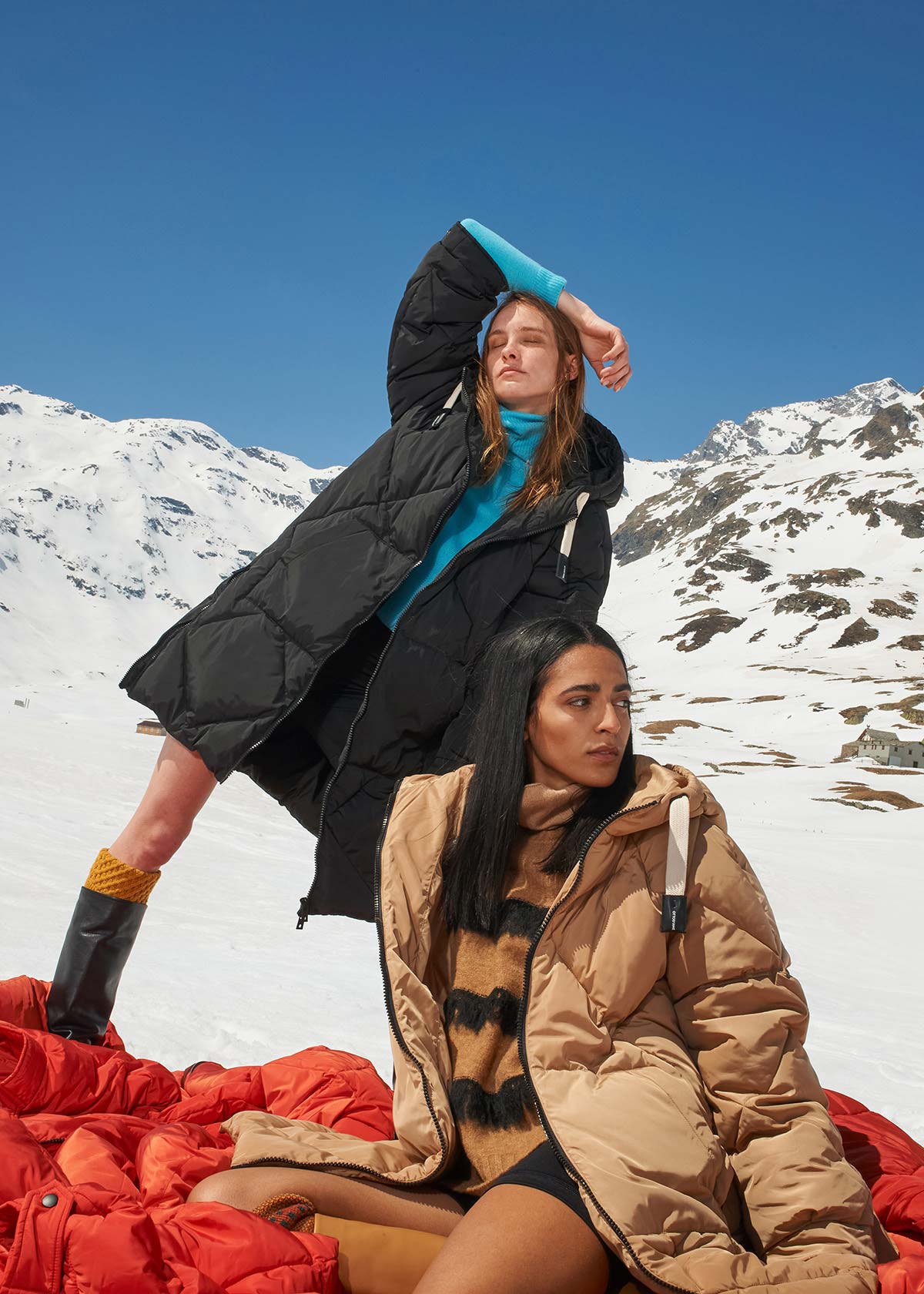 Models in the snow during a winter fashion campaign shot in the Italian Alps
